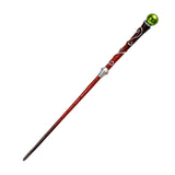 Decorative walking cane with a green top on a white background