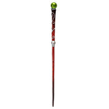 A decorative wand with a dark reddish-brown shaft, silver scrollwork, a silver band, and a shiny green spherical topper, shown against a plain white background.