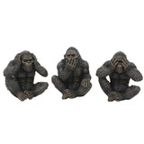 Three dark gray gorilla figurines seated side by side, each in a classic 'see no evil, hear no evil, speak no evil' pose with hands over head, mouth, and eyes, on a plain white background.