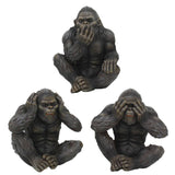 Three dark-finished gorilla figurines seated in the classic 'three wise men' poses, shown on a plain white background.