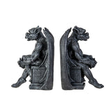 A pair of gothic gargoyle bookends shaped like seated winged demons, shown from the side on a plain white background.