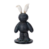 A textured black rabbit figurine with long white shell-like ears, standing on a round black base against a plain white background.