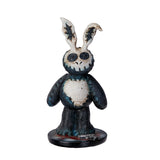 Skull-faced rabbit figurine with a dark blue and white color scheme on a white background