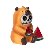 Skull-faced bear figurine holding watermelon slices on a white background