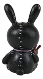 Black rabbit-shaped figure with white stitches on a white background