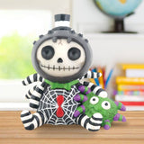 Skeleton plush toy with a spider on a wooden surface