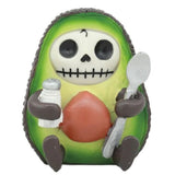 Avocado-shaped skeleton figurine holding a spoon and salt shaker on a white background