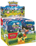 Pokémon trading card game packaging with cartoon characters and scenic design.