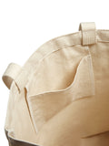 Close-up of a beige bag with straps on a white background