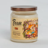 A glass jar candle with a copper-toned metal lid and a beige label featuring the scent name 'Rosemary Pork Pies' and an illustration of fantasy animals. The brand 'Cantrip Candles' is clearly visible on the front label.