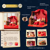 A product presentation graphic for a Harry Potter themed tea set miniature set, titled '03 Divination Class'. The image features a large main product shot of the red velvet tea set on a vintage wooden stand, alongside a book page showing a smaller version of the set, and four smaller inset images showing individual components: crystal balls, velvet tablecloth & round stakes, an explicable candle holder, and magical books.