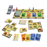 Board game set with a long rectangular playboard, multiple player cards, property tiles, money cards, and stacks of blue cards, arranged on a plain white background.