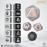 Set of dice with character symbols and a large D20 die on a white background, featuring 'The Hobbit' branding.