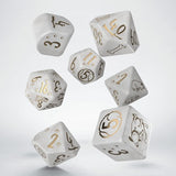 Set of white dice with gold and black numbers and symbols on a light gray background