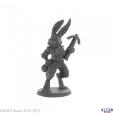 Gray rabbit-like figurine holding a weapon on a white background