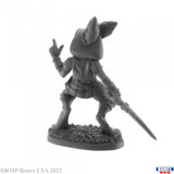 Gray miniature figurine of a fantasy character with a weapon on a white background