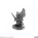 Minature figurine of a warrior with a helmet and sword on a white background