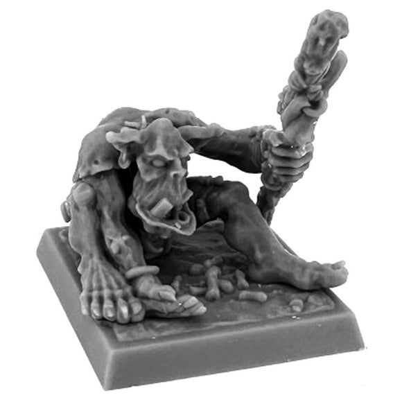 Gray miniature figurine of a creature holding a staff on a white background