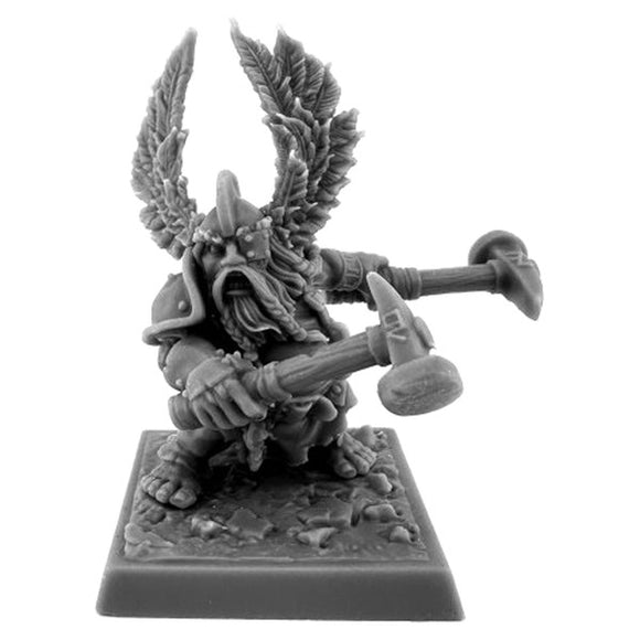 Gray miniature figurine of a fantasy warrior with horns and armor on a white background
