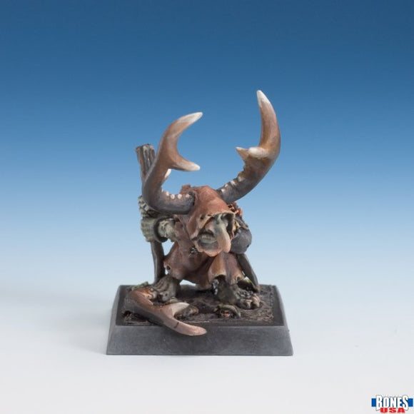 Miniature figurine with large antlers on a blue gradient background