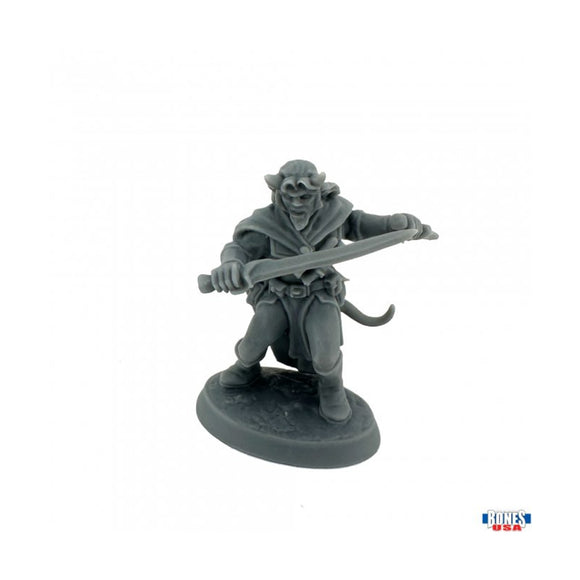 Gray miniature figure of a warrior with a sword on a white background