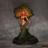 Fantasy figurine with colorful hair and dress on a dark background