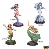 Four figurines representing the four seasons on a white background