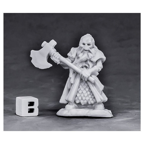 White dwarf figurine with an axe on a gray background