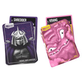 Two playing cards featuring Shredder and Krang characters on a white background
