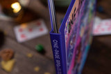 Close-up of a blue book titled 'One-Page RPG' with a blurred background