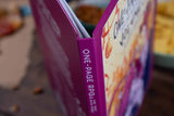 Close-up of a book titled 'One-Page RPGs' with a blurred background