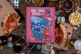 Book titled 'One Page RPGs Vol 4' on a table with pizza, drinks, and snacks