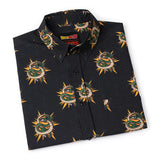 Folded black shirt with snake pattern on a white background