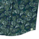 Green leaf-patterned shirt with dinosaur design on a white background