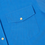 Close-up of a blue shirt with a pocket and button details