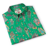 Folded green shirt with colorful character pattern on a white background
