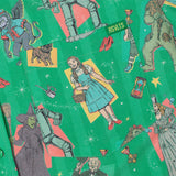 Patterned fabric with characters from 'The Wizard of Oz' on a green background