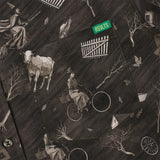 Patterned fabric with vintage-style illustrations including a woman on a bicycle, cow, and buildings.
