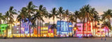 Colorful building facade with palm trees at night
