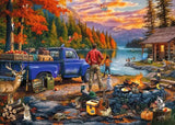 Camping scene with a blue truck, cabin, and people by a lake at sunset.