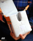 Product packaging with a white cushion and orange accents, held by a person.