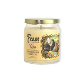 Candle jar with 'Feast' label and honeycomb design on a white background
