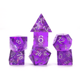 Set of purple polyhedral dice on a white background