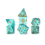 Set of turquoise polyhedral dice with gold numbers on a white background