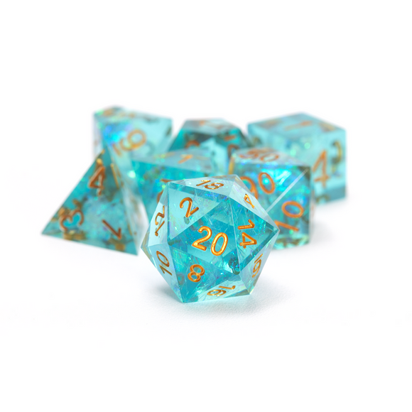 Set of turquoise polyhedral dice with gold numbers on a white background