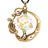 Pendant with a gold circular design and a clear die with gold numbers on a white background