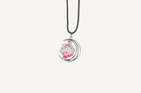 Necklace with a pink gemstone pendant on a white background