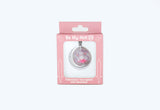 Valentine's Snowglobe D20 necklace in packaging on a white background