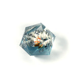 Clear polyhedral die with numbers on a white background
