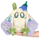 Plush toy resembling a character with a white body, green limbs, and purple wings held by a hand on a white background
